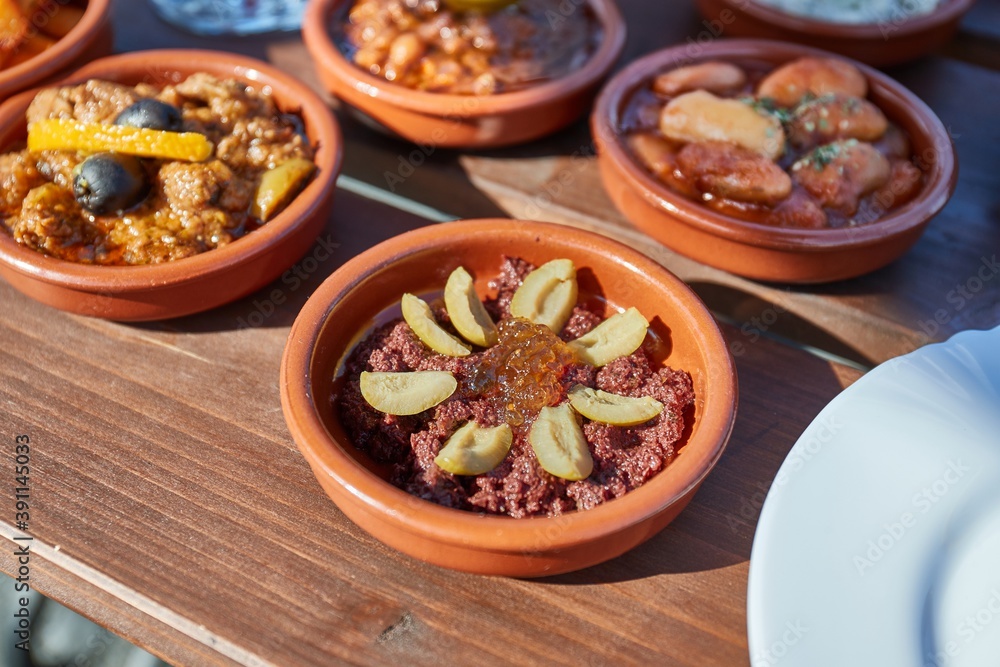 Tapas served at a restaurant with a variety of small plates Tapas served at a restaurant with a variety of small plates