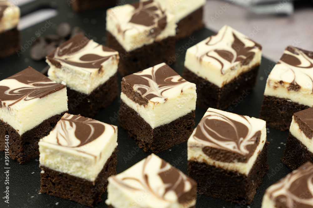 Cutting of homemade cheesecake swirl brownie or fudge Cutting of homemade cheesecake swirl brownie or fudge