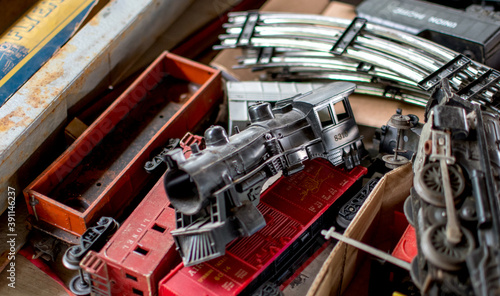 Box of model trains and track for sale at a hobby shop