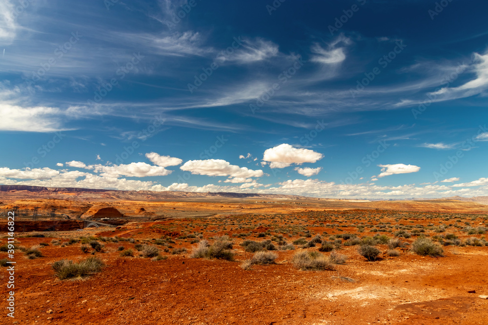Dark red soil and desert sand with beautiful skies and clouds near Page, AZ