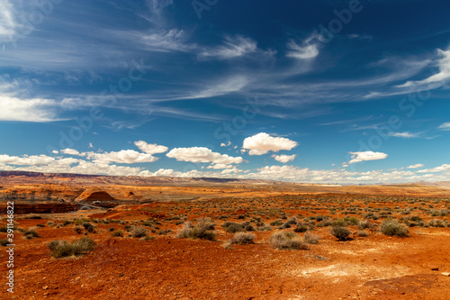 Obraz na płótnie Dark red soil and desert sand with beautiful skies and clouds near Page, AZ w salonie