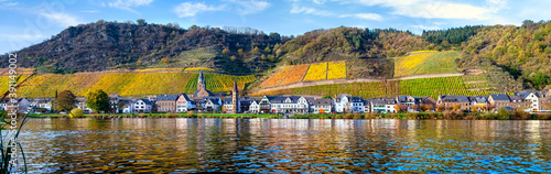 View over the river to the autumnal Hatzenport on the Moselle, Germany