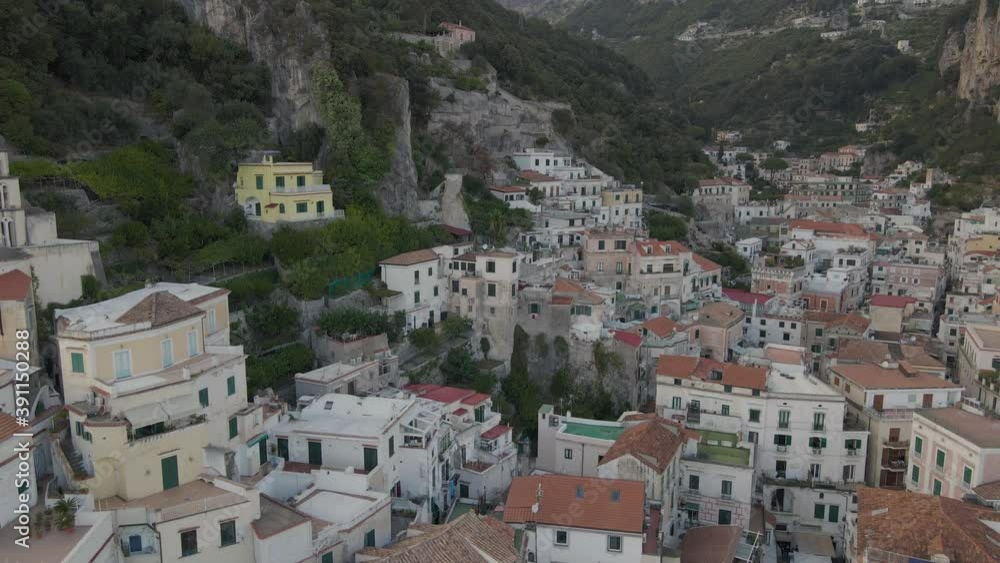 Amalfi, Italy. Aerial view of dense cityscape and residential houses under steep cliff by Mediterranean sea, drone shot Amalfi, Italy. Aerial view of dense cityscape and residential houses under steep cliff by Mediterranean sea, drone shot