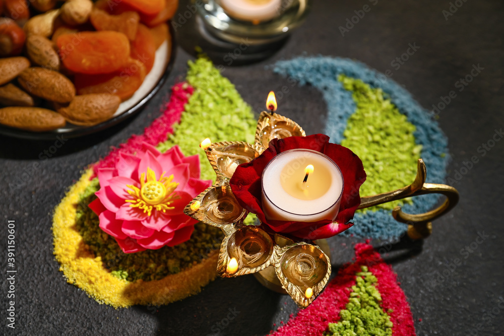 Festive composition with diya lamp for celebration of Divaly on dark background Festive composition with diya lamp for celebration of Divaly on dark background