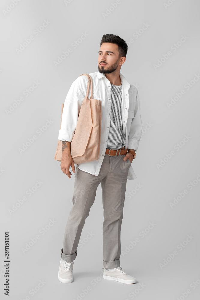 Fashionable young man on grey background Fashionable young man on grey background