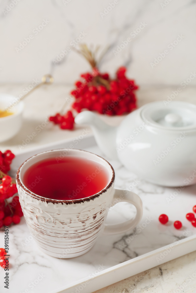Cup of healthy viburnum tea on table Cup of healthy viburnum tea on table