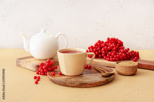 Cup of healthy viburnum tea on table