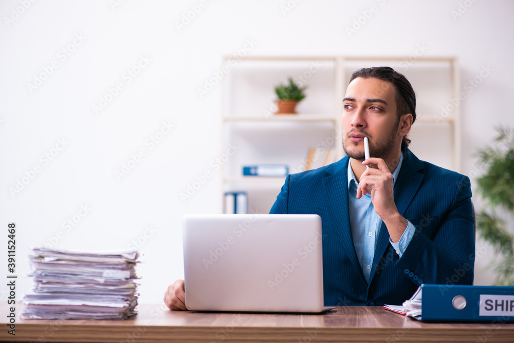 Young male businessman employee working in the office Young male businessman employee working in the office