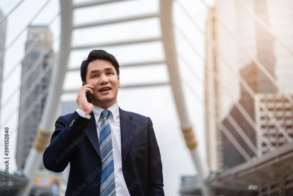 successful business man in suit talking a mobile phone in city successful business man in suit talking a mobile phone in city