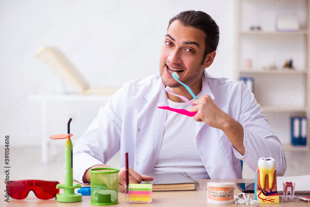 Young male dentist working in the clinic Young male dentist working in the clinic