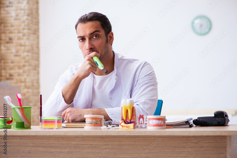 Fototapeta premium Young male dentist working in the clinic