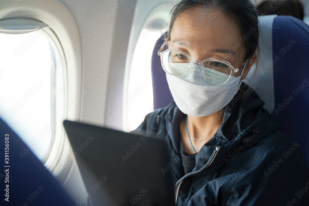 asian woman female air traveler reading ebook on flight asian woman female air traveler reading ebook on flight