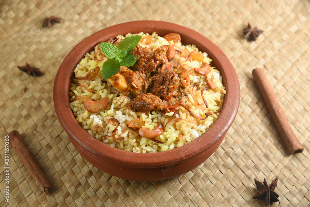 Mutton biryani , Gosht or lamb biryani or Hyderabadi Dum biriyani with raita yoghurt dip special occasion festival food for Ramadan , Eid Hyderabad India. Mutton biryani , Gosht or lamb biryani or Hyderabadi Dum biriyani with raita yoghurt dip special occasion festival food for Ramadan , Eid Hyderabad India.