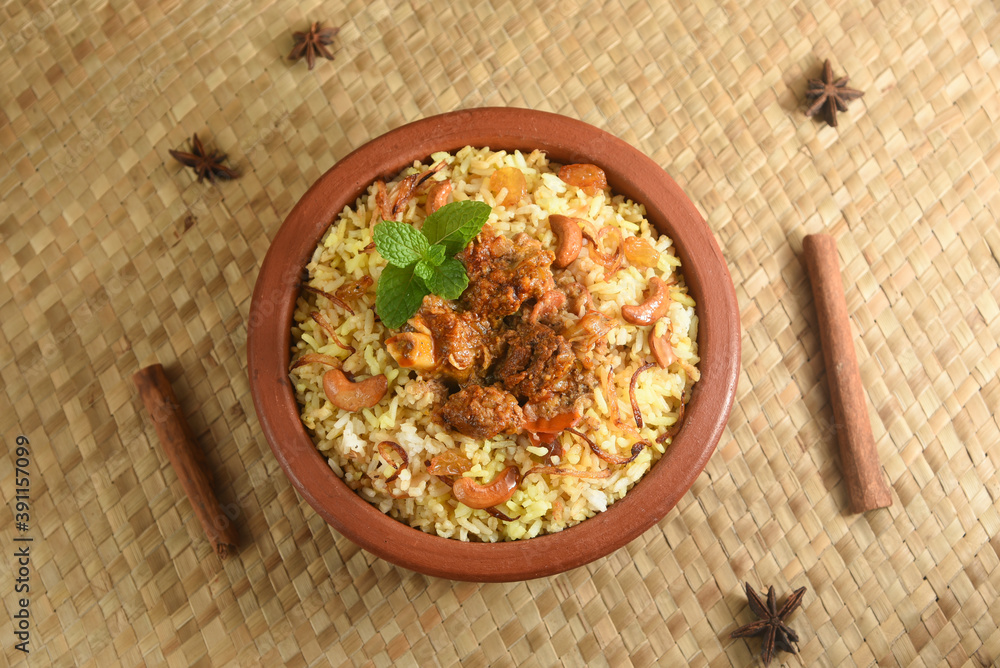Mutton biryani , Gosht or lamb biryani or Hyderabadi Dum biriyani with raita yoghurt dip special occasion festival food for Ramadan , Eid Hyderabad India in clay or earthen pot Mutton biryani , Gosht or lamb biryani or Hyderabadi Dum biriyani with raita yoghurt dip special occasion festival food for Ramadan , Eid Hyderabad India in clay or earthen pot