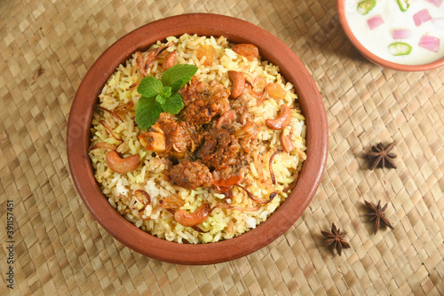 Mutton biryani , Gosht or lamb biryani or Hyderabadi Dum biriyani with raita yoghurt dip special occasion festival food  for Ramadan , Eid Hyderabad India.