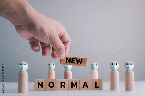 Quadro em tela NEW NORMAL, disruptive innovation way of post covid-19 coronavirus pandemic concept, wooden doll wear Face mask with word  NEW NORMAL on wood blocks