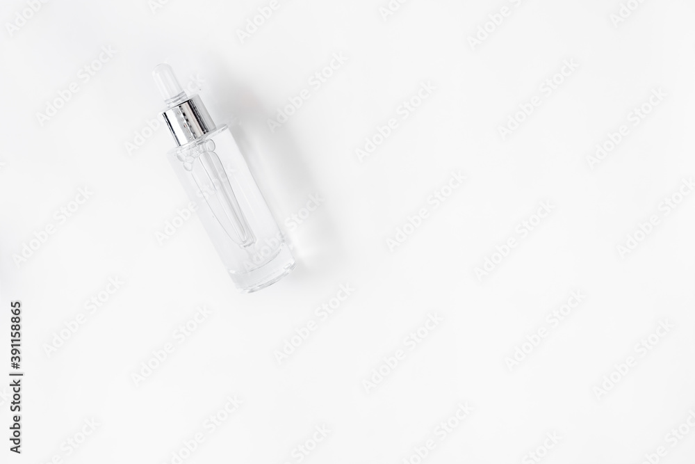 Glass Bottle with fluid collagen and hyaluronic acid, hydration skin. Top flatlay view copyspace. Abstract water background. Glass Bottle with fluid collagen and hyaluronic acid, hydration skin. Top flatlay view copyspace. Abstract water background.