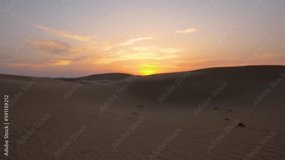 Walking over incredible Abu Dhabi Sand Dunes during a Magnificent Orange Sunset Walking over incredible Abu Dhabi Sand Dunes during a Magnificent Orange Sunset