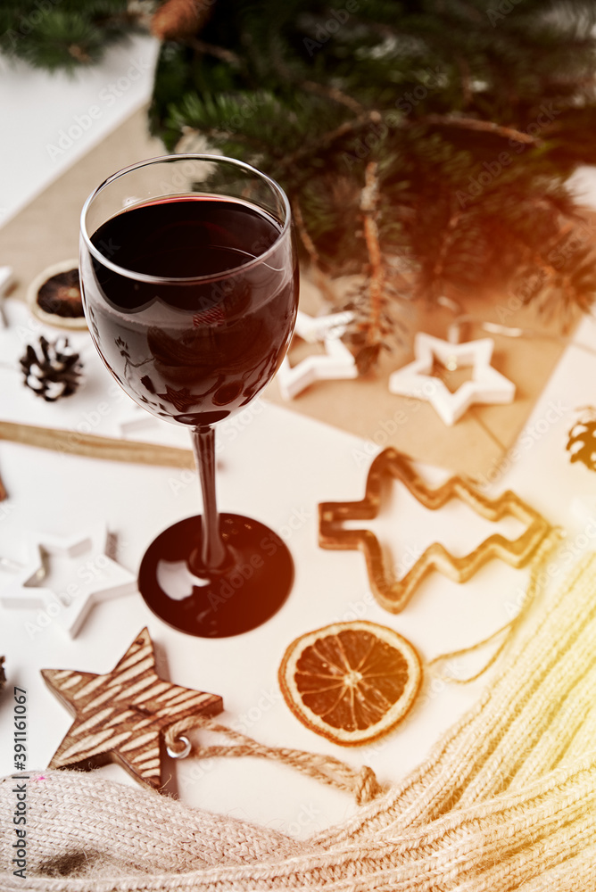 Glass of wine with christmas decorations. Hugge and cozy home background Glass of wine with christmas decorations. Hugge and cozy home background