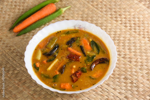 Kerala food for Onam festival special curry Sambar , Sambhar for Onam sadya , sadhya in green banana leaf background. popular Sri Lankan food . South Indian spicy vegetable curry vegan vegetarian dish photo