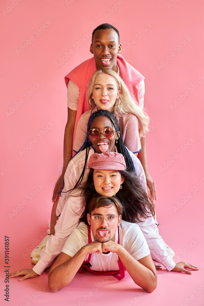 cheerful funny diverse people in a row isolated over pink background, different nationalities gathered in one place. people diversity concept