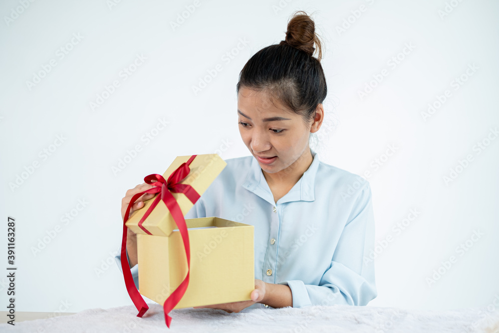 Asian women happy to open surprise boxes are stunned with excitement, joy, and smile on holidays, Christmas, birthday, or Valentine's Day concept Asian women happy to open surprise boxes are stunned with excitement, joy, and smile on holidays, Christmas, birthday, or Valentine's Day concept