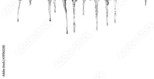 Icicles hang down. Close up. Isolated on a white background