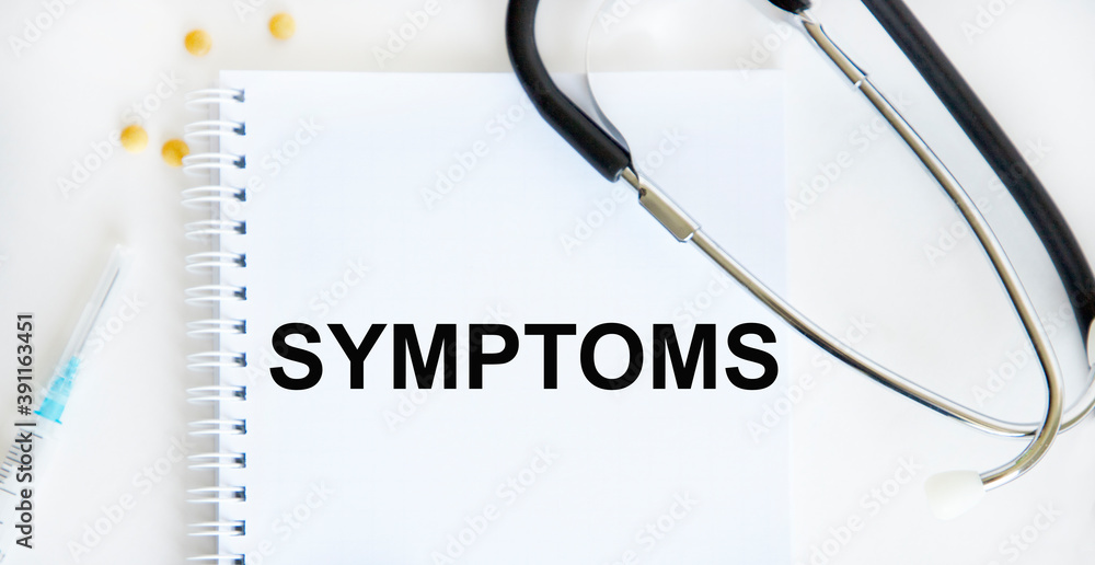 In the notebook is the text of SYMPTOMS, next to a stethoscope, a syringe, yellow tablets. In the notebook is the text of SYMPTOMS, next to a stethoscope, a syringe, yellow tablets.