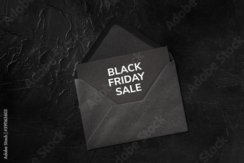 Black Friday Sale banner, a gift card in an envelope on a dark background, top shot