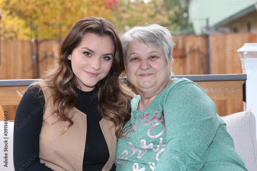 Close up Portrait of Happy Grandmother with short Silver hair and Beautiful 18 Years Old Granddaughter, Happy Family, Generation Close up Portrait of Happy Grandmother with short Silver hair and Beautiful 18 Years Old Granddaughter, Happy Family, Generation