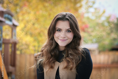 Close up Portrait of 18 Years Old Beautiful, Gorgeous Girl with Long Brown hair and Big eyes, Blurry Fall Background, Happy Teenager 