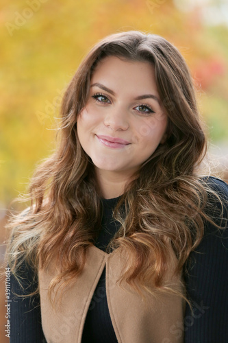 Close up Portrait of 18 Years Old Beautiful, Gorgeous Girl with Long Brown hair and Big eyes, Blurry Fall Background, Happy Teenager 