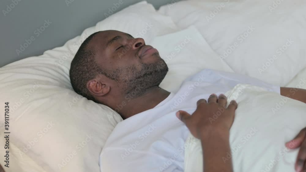 Peaceful Young African Man Sleeping in Bed Peaceful Young African Man Sleeping in Bed