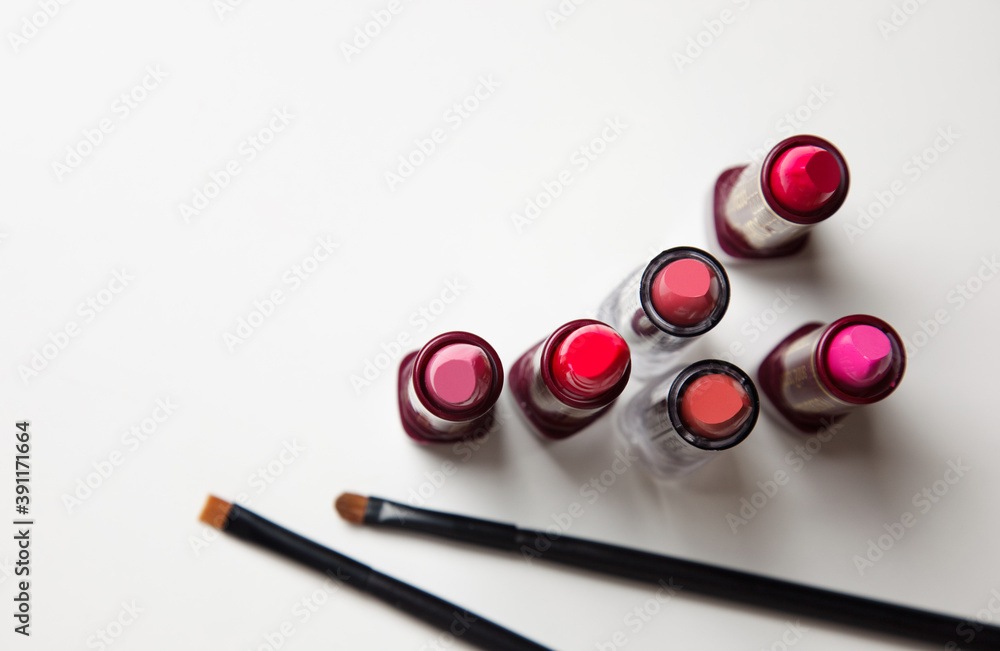 lipsticks and make-up brushes on white lipsticks and make-up brushes on white
