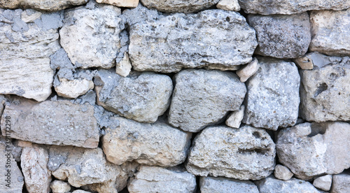 Stones in the wall of the house as an abstract background.