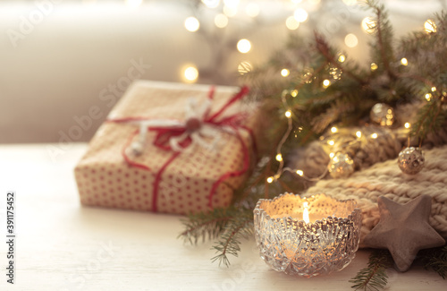 Christmas background with burning candles in the foreground. The concept of winter cozy and warmth.