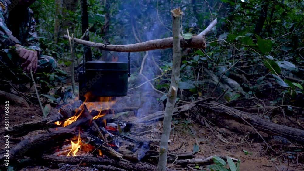 Cooking food with a field pots at the campfire in the forest. Cooking food with a field pots at the campfire in the forest.