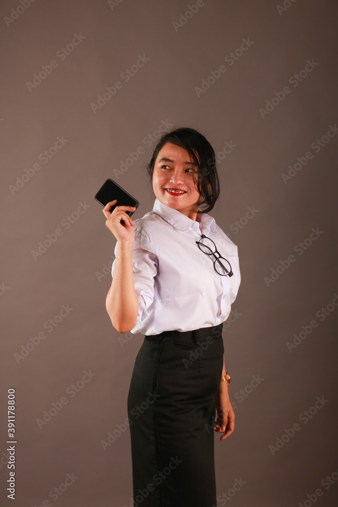Happy oriental Asian young executive using mobile phone. Happy oriental Asian young executive using mobile phone.