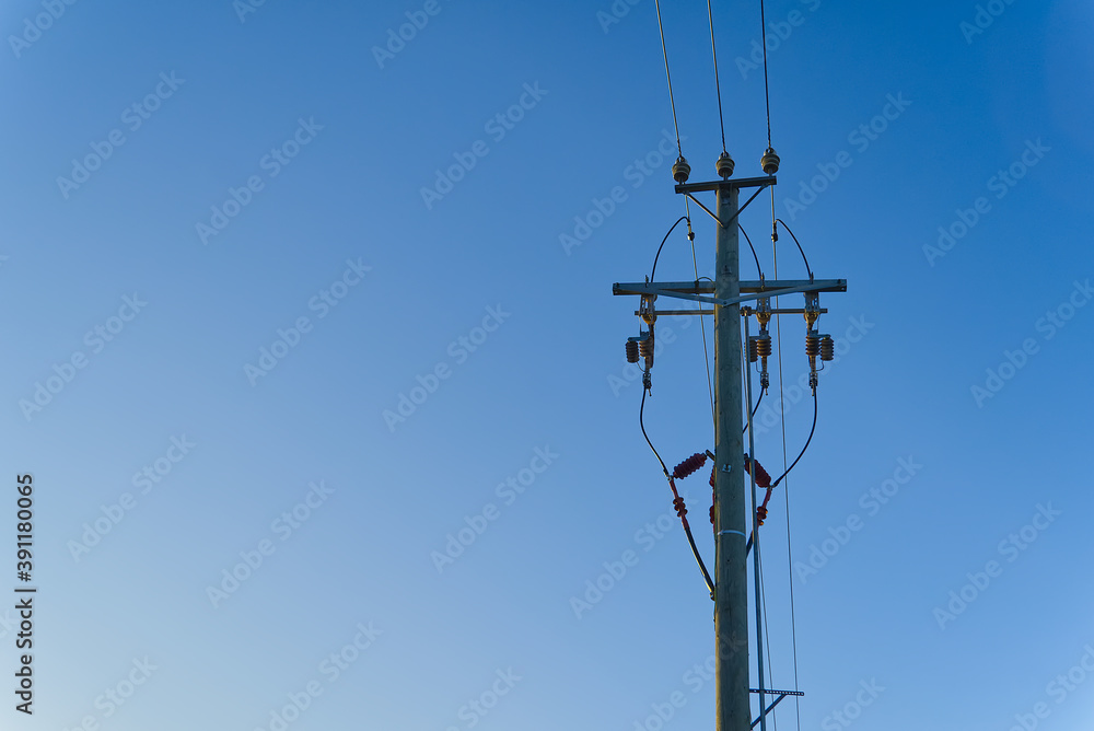 electric power sky lines and connections on a wooden post. wooden electricity post against blue sky. Electric power lines and wires with blue sky. electric power sky lines and connections on a wooden post. wooden electricity post against blue sky. Electric power lines and wires with blue sky.