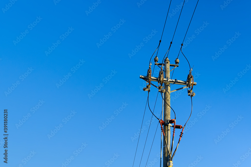 electric power sky lines and connections on a wooden post. wooden electricity post against blue sky. Electric power lines and wires with blue sky. electric power sky lines and connections on a wooden post. wooden electricity post against blue sky. Electric power lines and wires with blue sky.