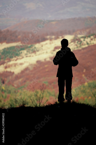 Silhouette of a man looking at the mountain view