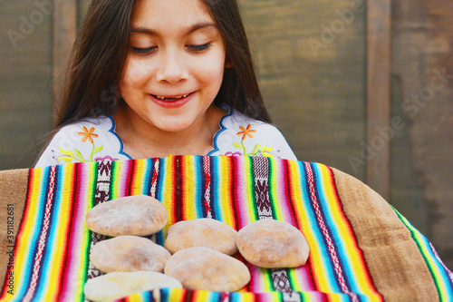 Happy latin little girl with traditional buns. photo