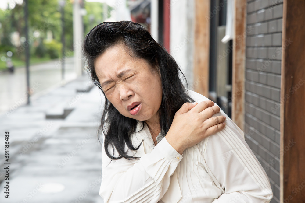 old senior woman suffers from shoulder joint pain, shoulder stiffness or osteoporosis old senior woman suffers from shoulder joint pain, shoulder stiffness or osteoporosis