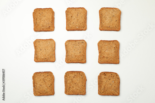 Flat lay with dark bread slices on white background
