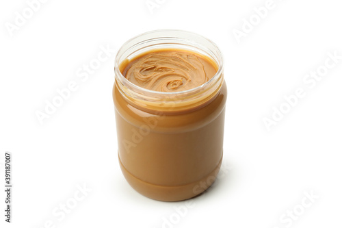 Jar with tasty peanut butter isolated on white background