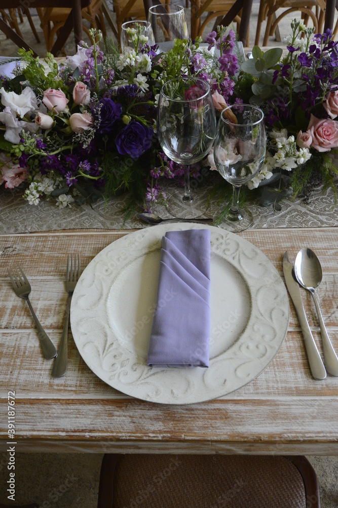 Table prepared for a wedding with purple flowers Table prepared for a wedding with purple flowers