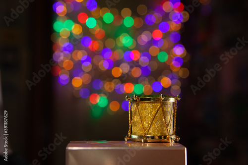 Golden drums with colorful lights that form the bokeh of the background.