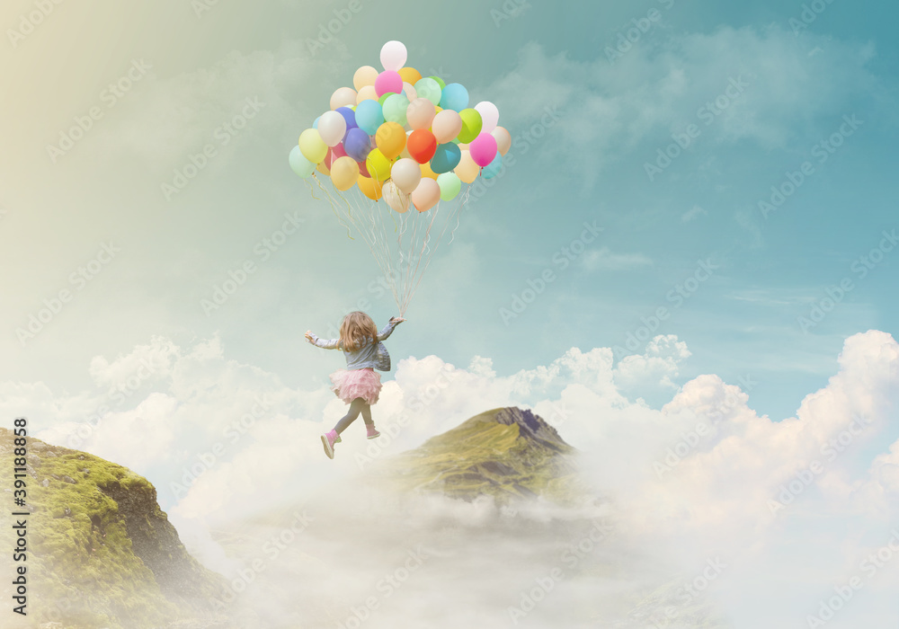 Little girl holding colorful balloons, jumping from one mountain top to the other; success/achievement concept, fantasy background with copy space - obrazy, fototapety, plakaty 