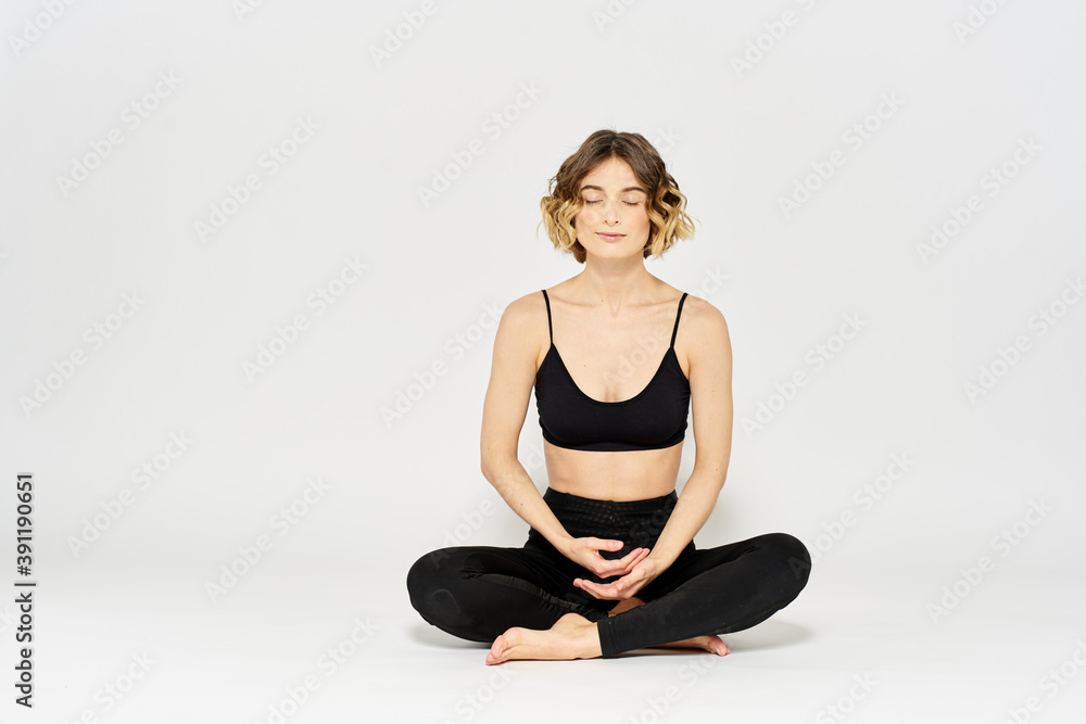 Yoga asana woman crossed legs meditation light background room