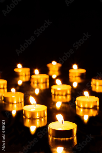 Tea candles burning in the dark